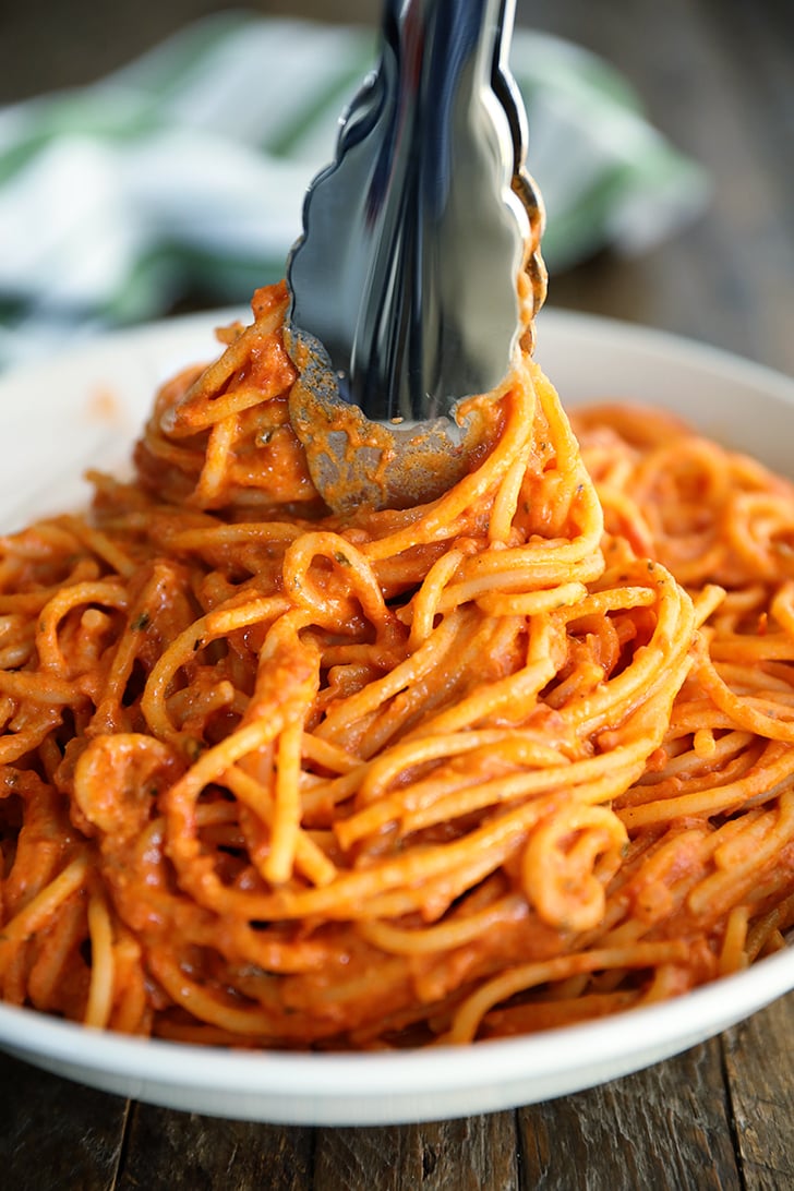 Tongs swirling 3-Ingredient Tomato and Boursin Pasta in a bowl.